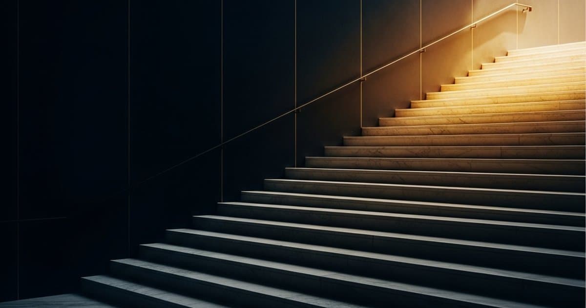 Illuminated tiered steps ascending from shadow to gold light, representing commercial borrower credit tiers